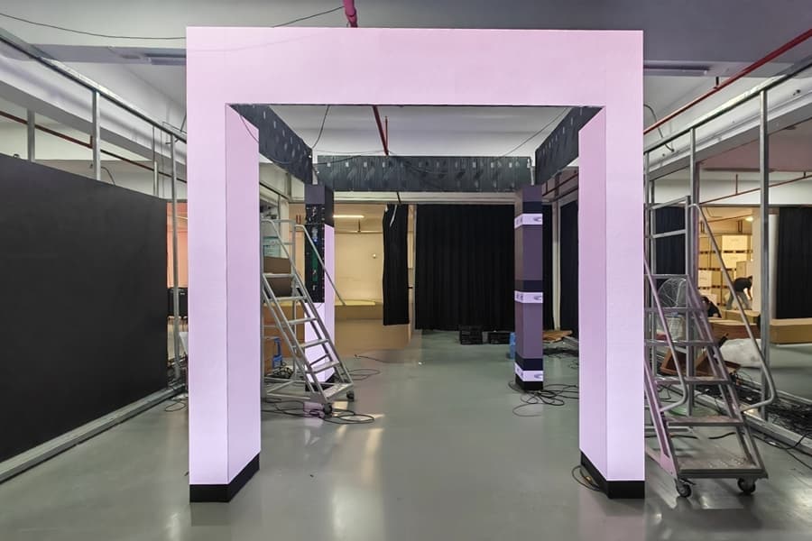 Custom flat LED display with dual door-shaped cutouts integrated into modern building facade for high-tech architectural appeal