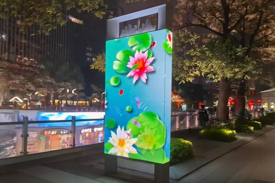 Outdoor integrated release LED advertising machine installed on roadside commercial location with high brightness clear screen effect under natural sunlight